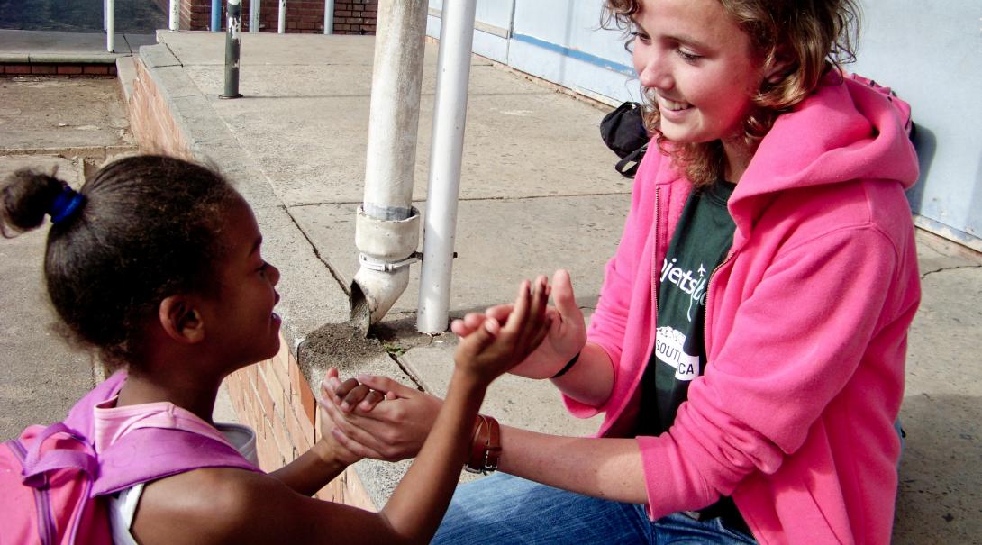 Projects Abroad volunteer works with a South Africa child during her gap year in 2019 Global Gap Year programme volunteer plays a game with a child during her project in South Africa